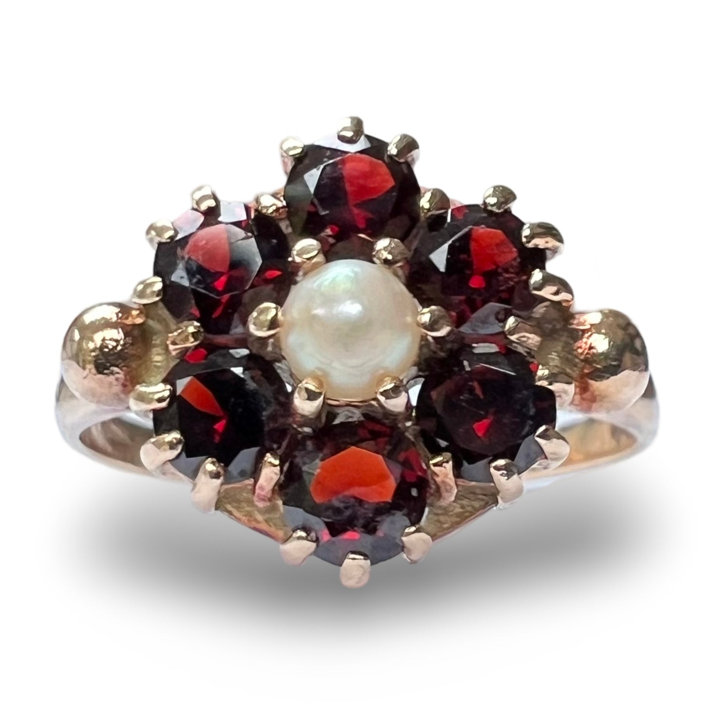 Front view of vintage 9ct gold cluster ring featuring a central pearl surrounded by garnets