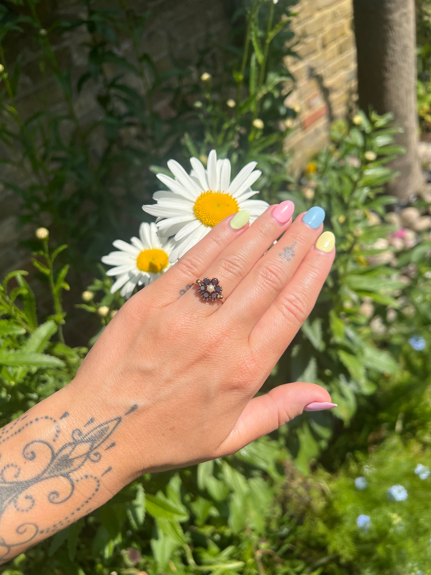 Vintage 9ct gold pearl and garnet cluster ring shown on finger for scale