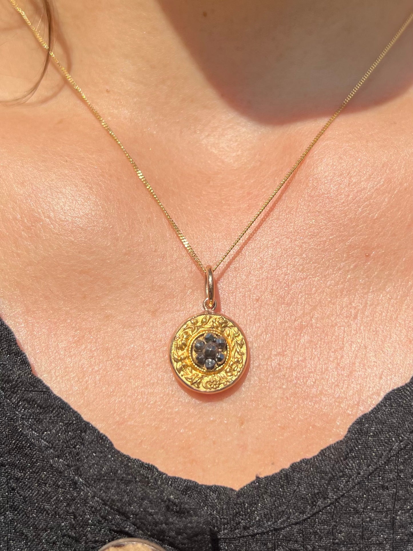 Victorian gold floral pendant with central cut steel daisy.